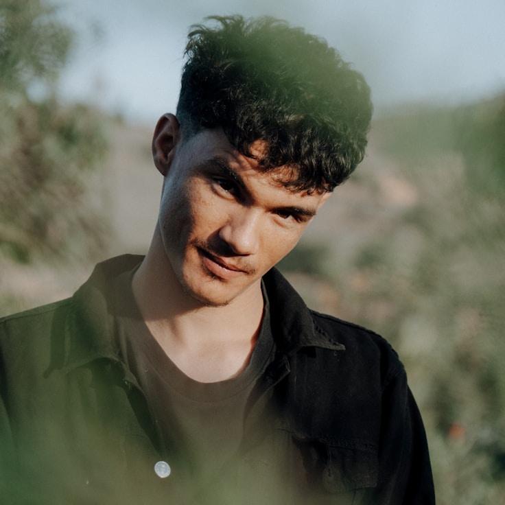 Alex Rivera, Lead Design Curator at PilotKeystoneWave, reviewing corporate floral arrangements